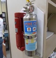 A flashlight and a small fire extinguisher are standard equipment in an office.